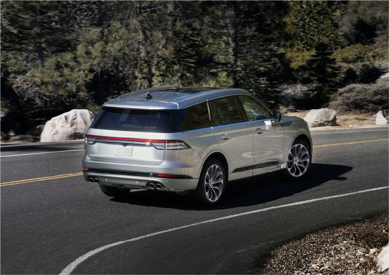 A 2023 Lincoln Aviator® Grand Touring model is shown being driven on a tight turn of a mountain road | Dorsch Lincoln in Green Bay WI