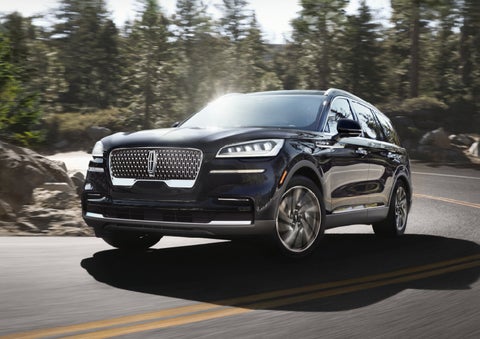 A Lincoln Aviator® SUV is being driven on a winding mountain road | Dorsch Lincoln in Green Bay WI