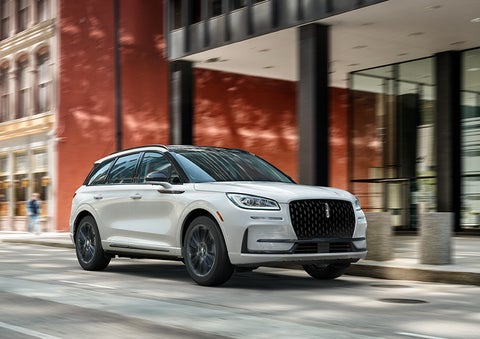The 2024 Lincoln Corsair® SUV with the Jet Appearance Package and a Pristine White exterior is parked on a city street. | Dorsch Lincoln in Green Bay WI
