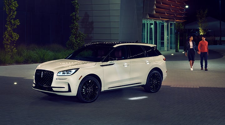 Two people approach a 2024 Lincoln Corsair® SUV featuring the available Jet Appearance Package. | Dorsch Lincoln in Green Bay WI