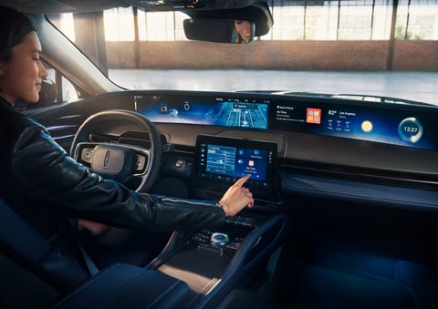 The driver of a 2024 Lincoln Nautilus® SUV interacts with the center touchscreen. | Dorsch Lincoln in Green Bay WI