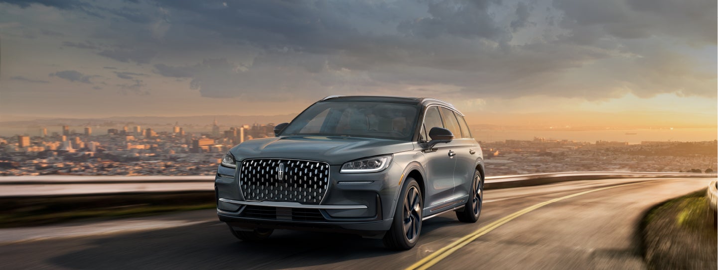 A 2024 Lincoln Corsair® Grand Touring SUV is being driven on a hillside road.