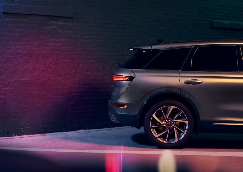 A dramatization of a 2025 Lincoln Corsair® SUV is shown backing up toward a wall. | Dorsch Lincoln in Green Bay WI