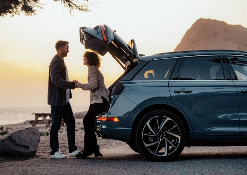A couple share a moment together outside a 2025 Lincoln Corsair® SUV near the open liftgate. | Dorsch Lincoln in Green Bay WI