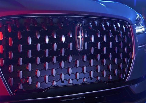 The grille of a 2025 Lincoln Corsair® SUV reflects neon light at night. | Dorsch Lincoln in Green Bay WI