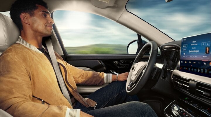 A person is shown using Lincoln BlueCruise hands-free highway driving technology on a divided highway called a Hands-Free Blue Zone. | Dorsch Lincoln in Green Bay WI