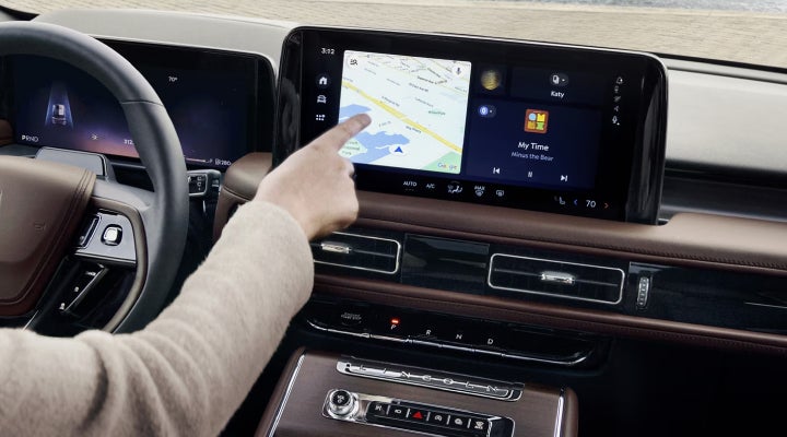 A person is tapping the center display touchscreen of a 2026 Lincoln Aviator® SUV. | Dorsch Lincoln in Green Bay WI