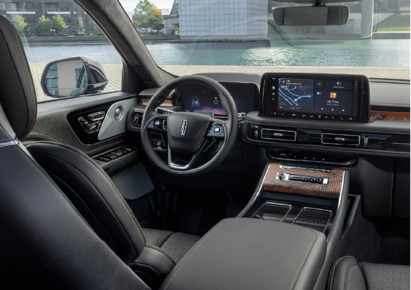 The interior of the 2026 Lincoln Aviator® SUV is shown parked with a view of a harbor through the windshield. | Dorsch Lincoln in Green Bay WI