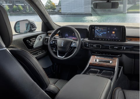 The interior of the 2026 Lincoln Aviator® SUV is shown parked with a view of a harbor through the windshield. | Dorsch Lincoln in Green Bay WI