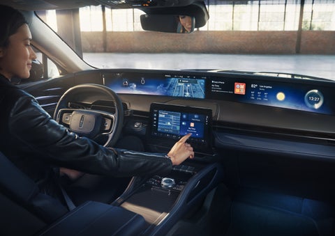 The driver of a 2026 Lincoln Nautilus® SUV interacts with the center touchscreen. | Dorsch Lincoln in Green Bay WI