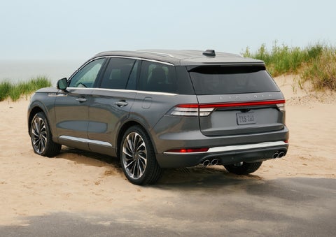 A 2027 Lincoln Aviator® SUV is parked next to sand dunes. | Dorsch Lincoln in Green Bay WI