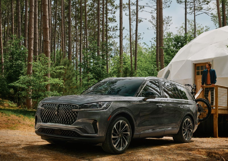 A 2027 Lincoln Aviator® is parked next to a high end glamping site. | Dorsch Lincoln in Green Bay WI