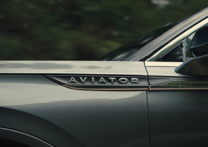 The driver’s side door and fender badging of a gray 2027 Lincoln Aviator® SUV are showcased. | Dorsch Lincoln in Green Bay WI