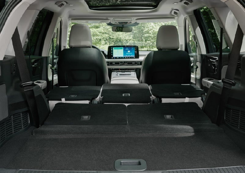 A rear to front view of the interior of a 2027 Lincoln Aviator® Black Label™ SUV shows the third and second rows folded flat | Dorsch Lincoln in Green Bay WI