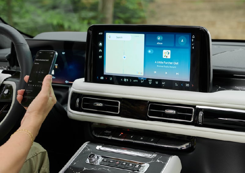 A person pairs thier phone with the center touchscreen of a 2027 Lincoln Aviator® Black Label™ SUV | Dorsch Lincoln in Green Bay WI